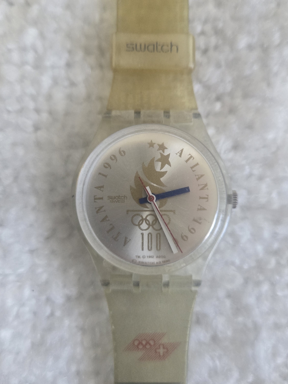 Swatch gold translucent Olympic motif watch with blue and red hands